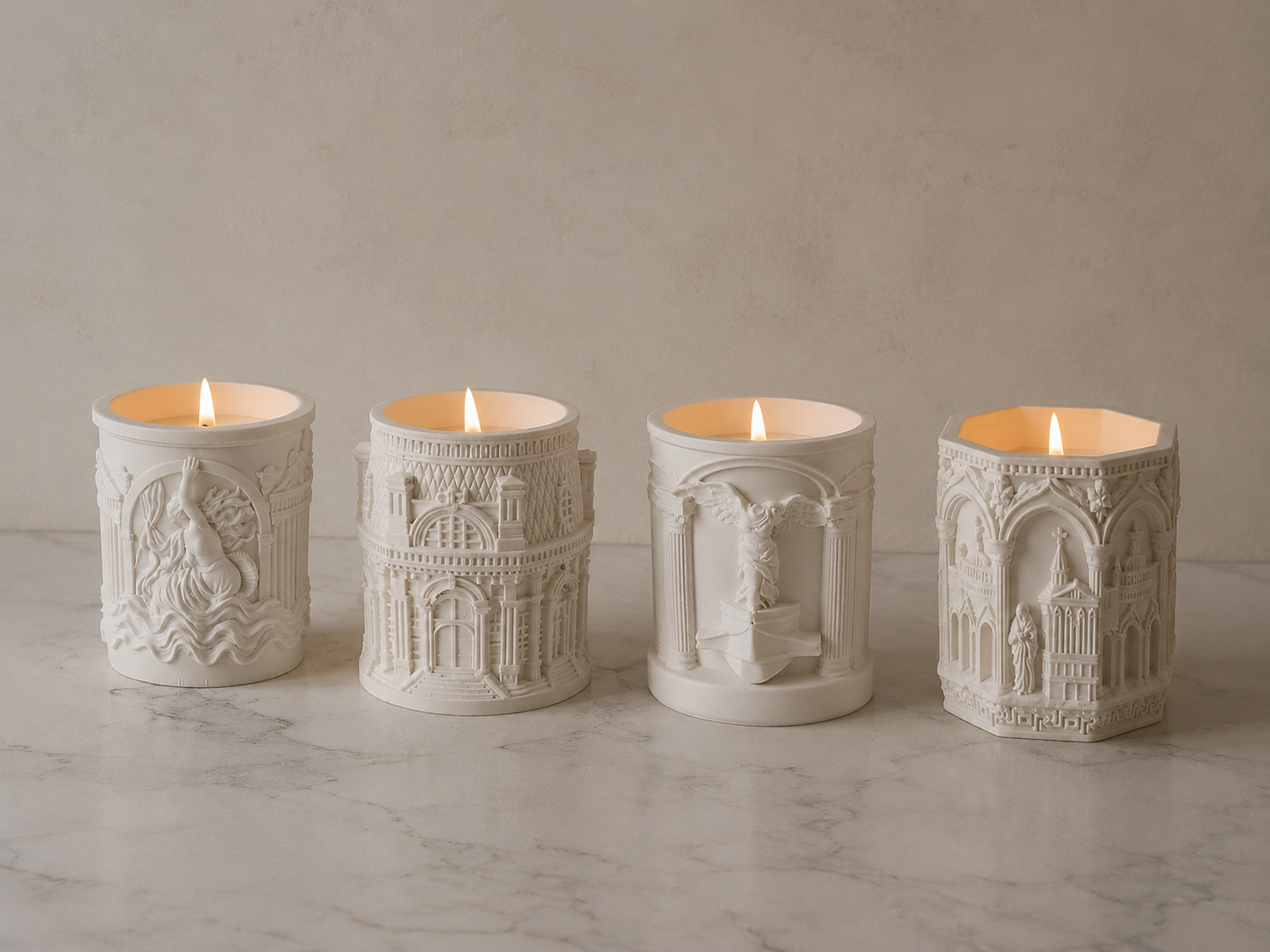 Set of 4 handmade gypsum candle holders with architectural relief soy candles burning marble background | MOSVAM
